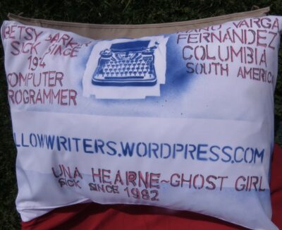 A pillowcase from the Pillow Writers group with the names of three members of the group, a typewriter, and the link to pillowwriters.wordpress.com.