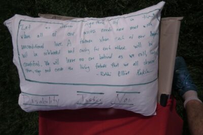 A white pillowcase with green writing on it