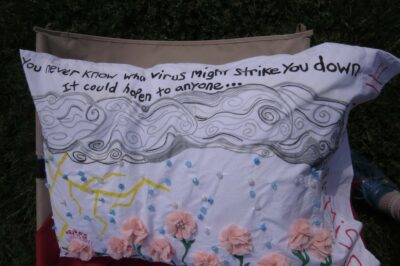 a white pillow with pink flowers, a thunderstorm and text on it