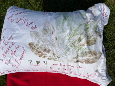 A white pillowcase with printed leaf prints and names