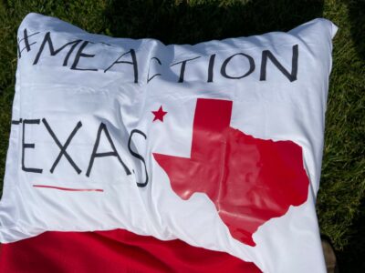 #MEACTION TEXAS written on a pillowcase with a red drawing of Texas