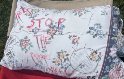 A floral pillowcase that has writing on it