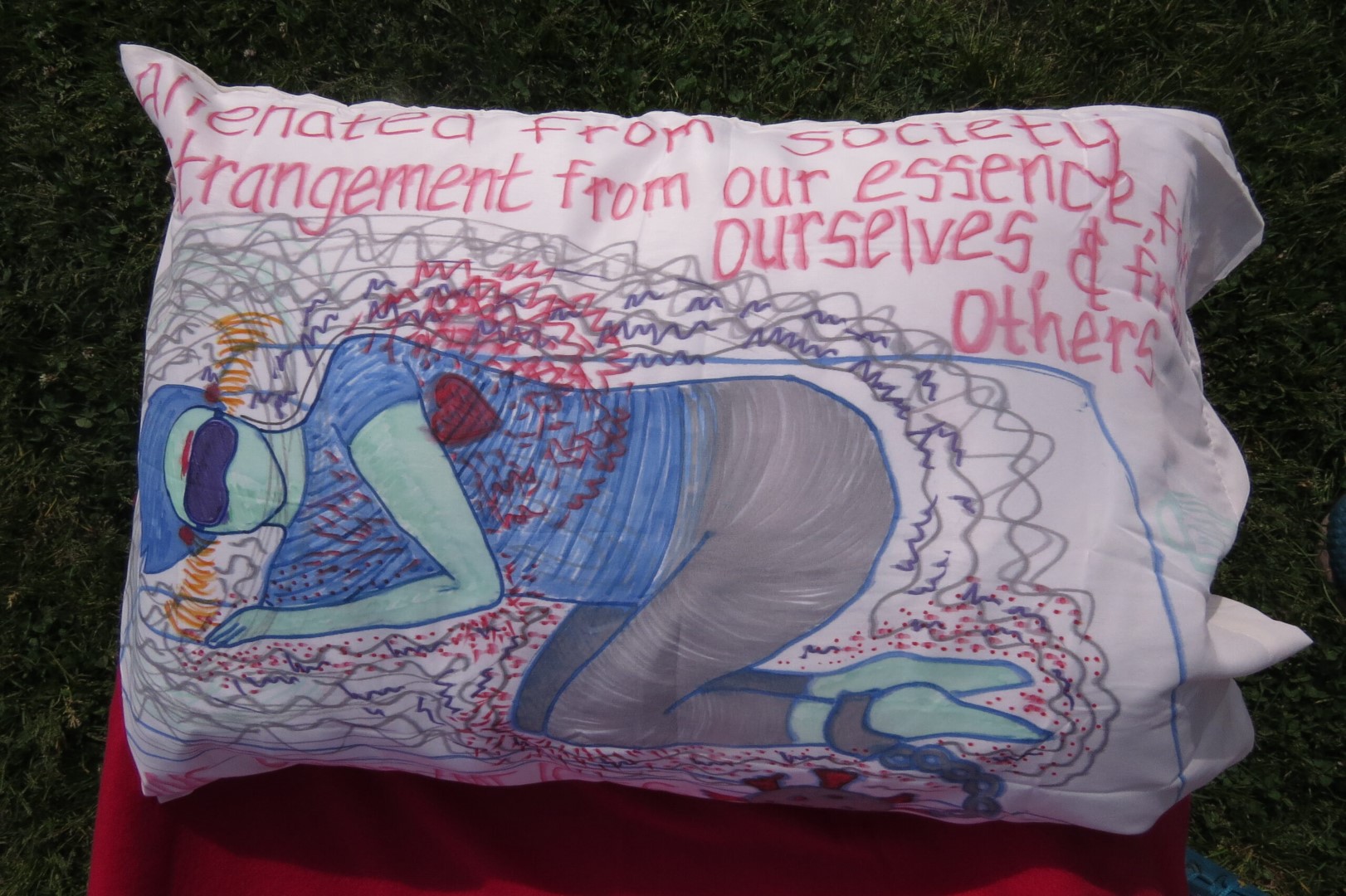 A red pillowcase with a blue drawing of a of a man with words that says and who gets to measure